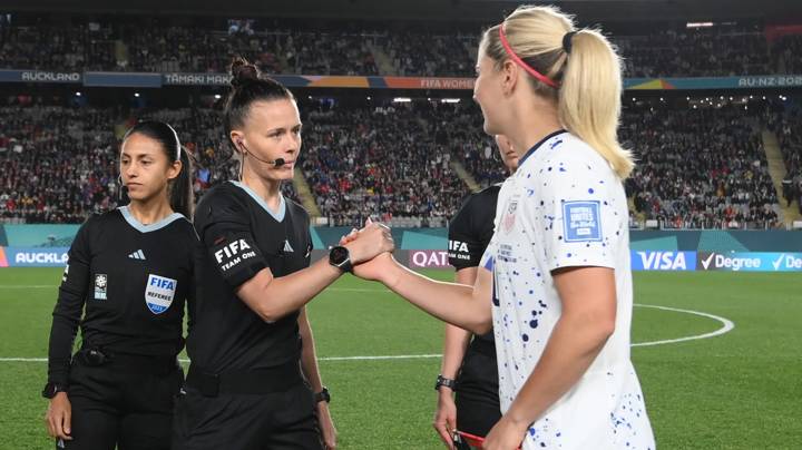 Captain Lindsey Horan of USA shakes hands with referee Rebecca Welch