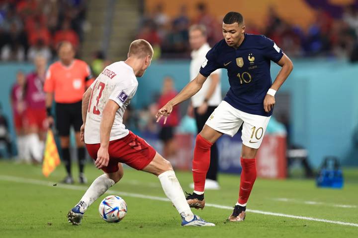 Kylian Mbappe of France controls the ball against Rasmus Kristensen