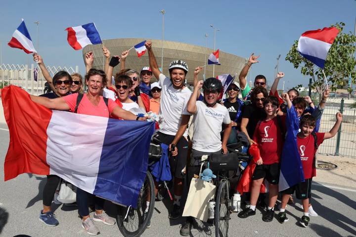 French soccer fans Gabriel Martin (center R) and Mehdi Balamissa (center L), who cycled from Paris for the Qatar 2022 World Cup