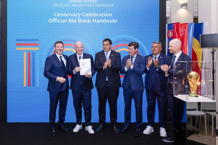 FIFA President Gianni Infantino and FIFA Secretary General Mattias Grafström receive the Centenary Celebration Official Bid Book 