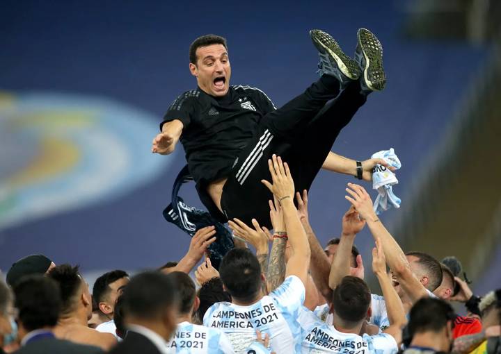 The Argentina players throw coach Lionel Scaloni up in the air after their Copa Ameirca conquest.