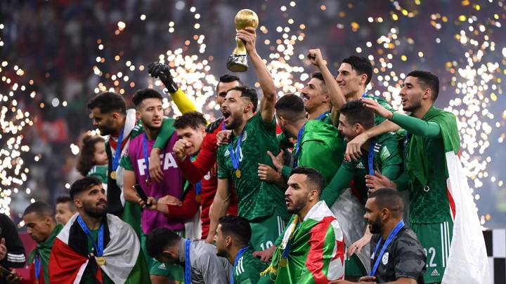 AL KHOR, QATAR - DECEMBER 18: Mohammed Belaili of Algeria lifts the FIFA Arab Cup trophy following victory during the FIFA Arab Cup Qatar 2021 Final match between Tunisia and Algeria at Al Bayt Stadium on December 18, 2021 in Al Khor, Qatar. (Photo by David Ramos - FIFA/FIFA via Getty Images)