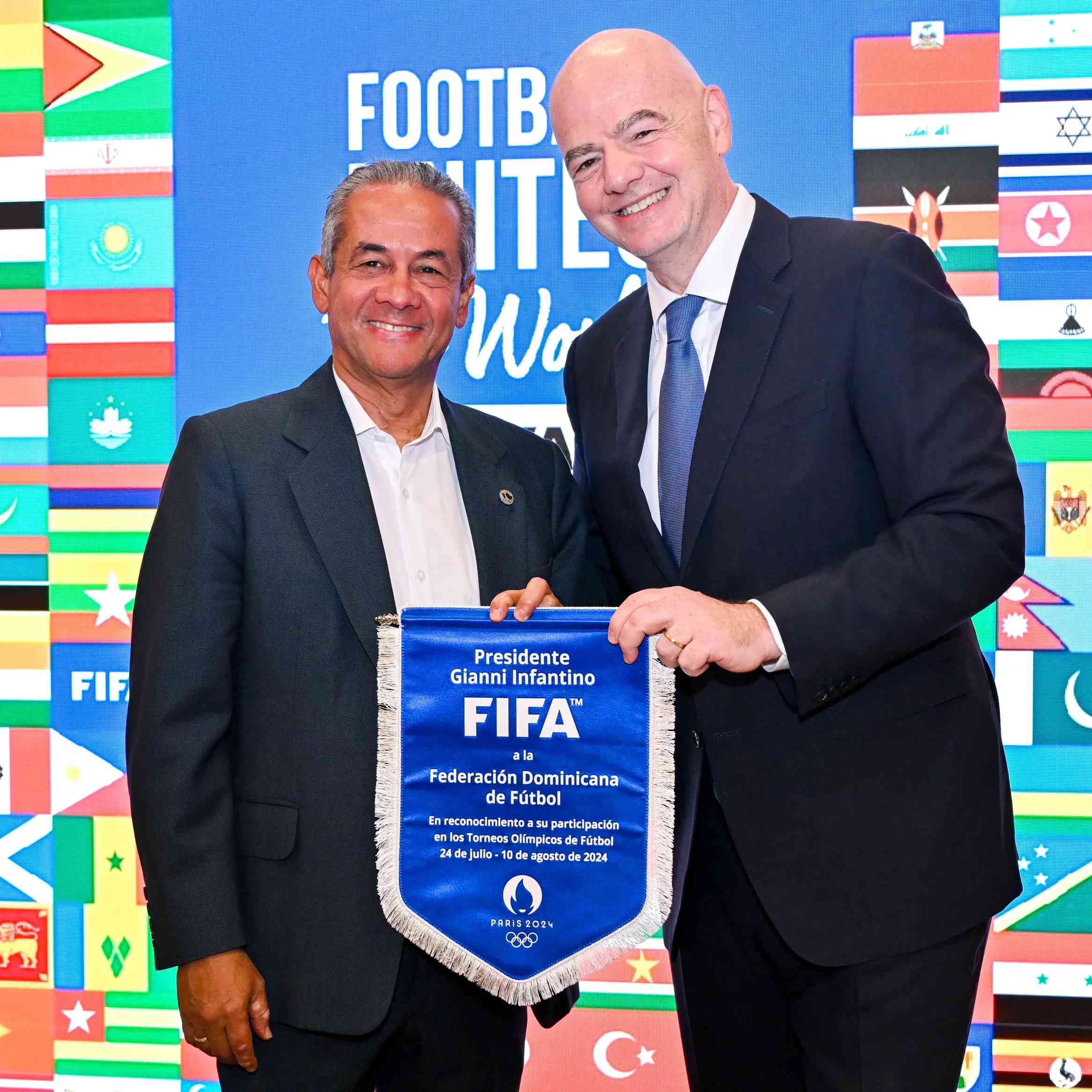 PARIS, FRANCE - JULY 22: FIFA President Gianni Infantino and Dominican Republic Football Association President Jose Deschamps pose for a photo with pennant during the Celebratory Lunch on the sidelines of the Olympic Games Paris 2024 at FIFA Paris offices on July 22, 2024 in Paris, France. (Photo by Harold Cunningham/FIFA)