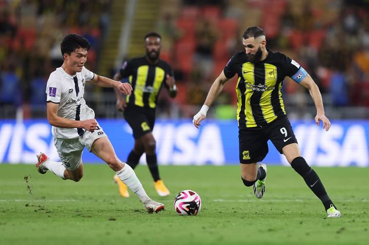 Joseph Lee of Auckland City battles for possession with Karim Benzema of Al Ittihad 