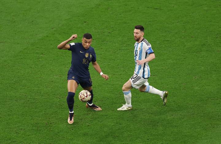 Kylian Mbappe of France controls the ball against Lionel Messi of Argentina during the FIFA World Cup Qatar 2022 Final 