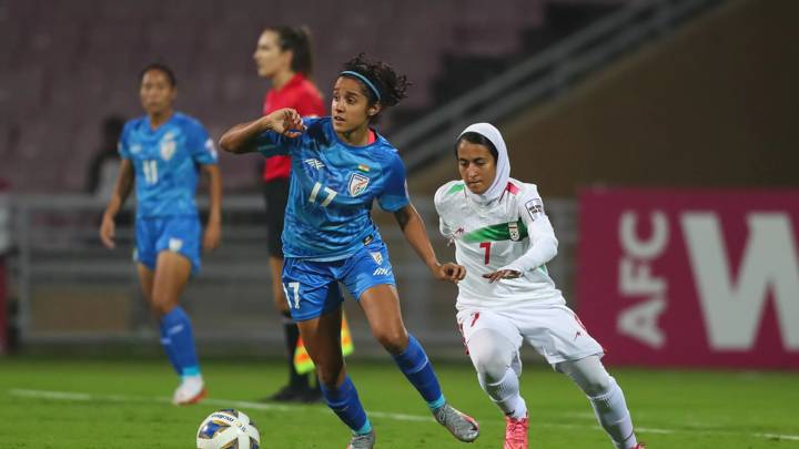 NAVI MUMBAI, INDIA - JANUARY 20: Dalima Chhibber of India and Afsaneh Chatrenoor of Iran vie for the ball during the AFC Women's Asian Cup Group A match between India and Iran at DY Patil Stadium on January 20, 2022 in Navi Mumbai, India. (Photo by Thananuwat Srirasant/Getty Images)