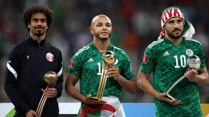 AL KHOR, QATAR - DECEMBER 18: Akram Afif of Qatar, Yacine Brahimi and Mohammed Belaili of Algeria pose with the Adidas Bronze Ball award, Adidas Gold Ball award and Adidas Silver Ball award following the FIFA Arab Cup Qatar 2021 Final match between Tunisia and Algeria at Al Bayt Stadium on December 18, 2021 in Al Khor, Qatar. (Photo by Cathrin Mueller - FIFA/FIFA via Getty Images)