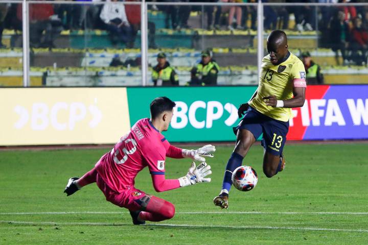 Enner Valencia of Ecuador battles for possession with Guillermo Viscarra of Bolivia