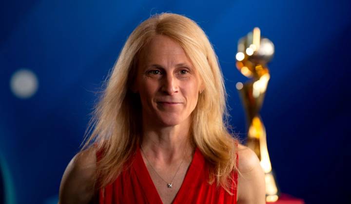 Kristine Lilly pictured with the FIFAWWC trophy in 2019