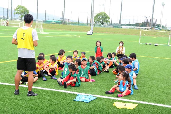 A coach instructs local kids during a training session in the  new Kumamoto Football Centre