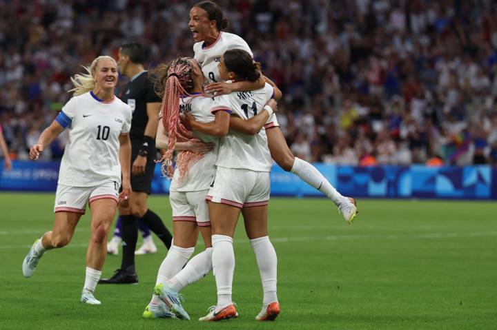 US' forward #11 Sophia Smith (front R) is congratulated after scoring in the women's group B football match between the USA and Germany during the Paris 2024 Olympic Games at the Marseille Stadium in Marseille on July 28, 2024. (Photo by Pascal GUYOT / AFP) (Photo by PASCAL GUYOT/AFP via Getty Images)