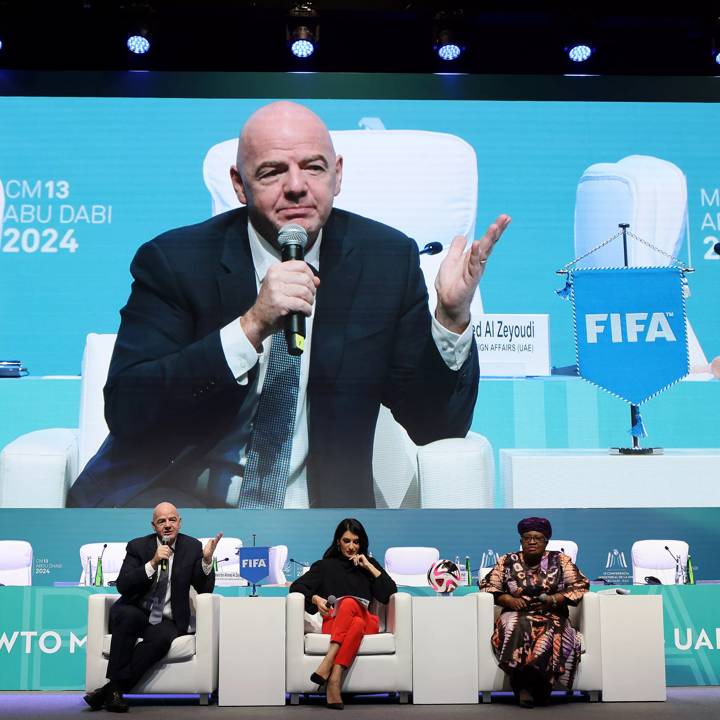 ABU DHABI, UNITED ARAB EMIRATES - FEBRUARY 24: FIFA President Gianni Infantino, CNN Anchor Eleni Giokos and WTO Director-General Ngozi Okonjo-Iweala during the FIFA and WTO High Level MC13 Side-Event on Cotton on February 24, 2024 in Abu Dhabi, United Arab Emirates. (Photo by Chris Pike - FIFA/FIFA via Getty Images)