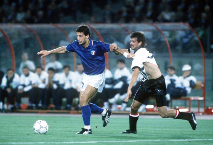 Italy's Gianluca Vialli takes the ball past Austria's Kurt Russ