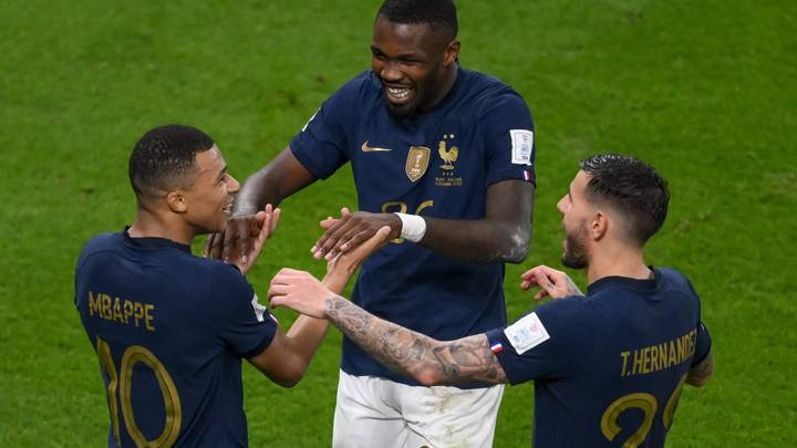 DOHA, QATAR - DECEMBER 04: Kylian Mbappe of France is congratulated by team-mates Marcus Thuram and Theo Hernandez (R) after scoring his side's third goal during the FIFA World Cup Qatar 2022 Round of 16 match between France and Poland at Al Thumama Stadium on December 04, 2022 in Doha, Qatar. (Photo by Stephen McCarthy/FIFA)