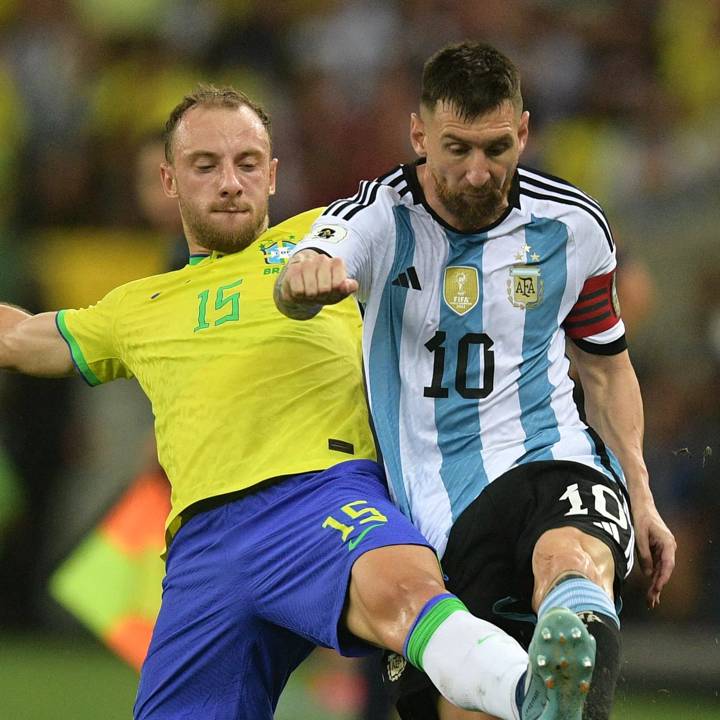 Brazil's defender Carlos Augusto (L) and Argentina's forward Lionel Messi fight for the ball during the 2026 FIFA World Cup South American qualification football match between Brazil and Argentina at Maracana Stadium in Rio de Janeiro, Brazil, on November 21, 2023. (Photo by CARL DE SOUZA / AFP) (Photo by CARL DE SOUZA/AFP via Getty Images)