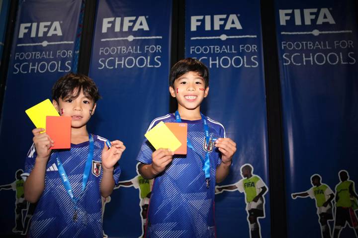 Two kids with the shirt of Japan during the Football for Schools Activities