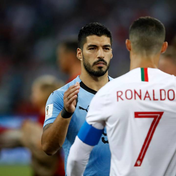 SOCHI, RUSSIA - JUNE 30: Luis Suarez of Uruguay sahkes hands wuth Cristiano Ronaldo of Portugal during the 2018 FIFA World Cup Russia Round of 16 match between Uruguay and Portugal at Fisht Stadium on June 30, 2018 in Sochi, Russia. (Photo by Julian Finney/Getty Images)