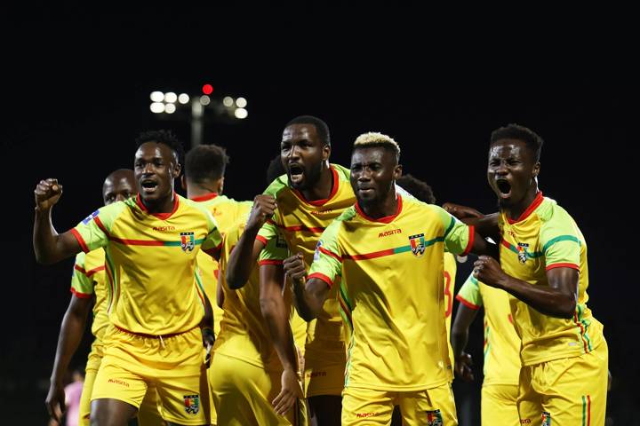 Morlaye Sylla of Guinea celebrates with teammates after scoring 