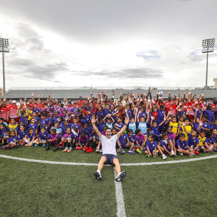 BELIZE CITY, BELIZE - AUGUST 17: FIFA Technical Consultant Juan Pablo Ángel poses with attendees for a group photo during Football for Schools at Princess Ramada Hotel on August 17, 2022 in Belize City, Belize. (Photo by Ivan Valencia/FIFA)