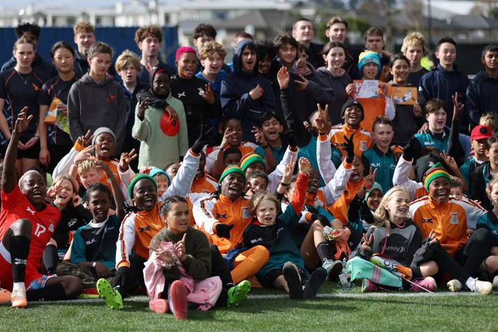 Players of Zambia pose for a photo with local children during a Zambia Training Session in Hamilton, New Zealand