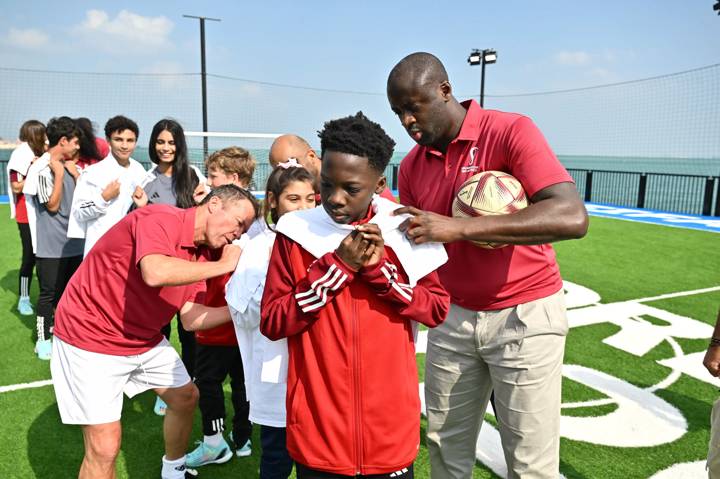 Yaya Toure signs autographs for a member of the youth programme