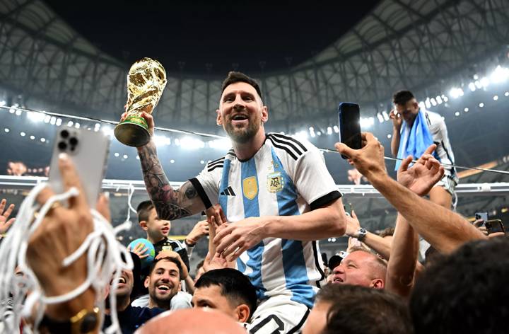 Lionel Messi of Argentina celebrates with the World Cup Trophy 